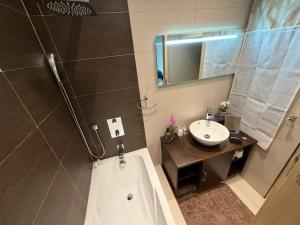 a bathroom with a bath tub and a sink at S'Agapo Maisonette St' Julians in St. Julianʼs +12 photos