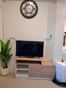 a living room with a flat screen tv on a stand at Sunday House - Fisherman Village Samui in Bophut +23 photos