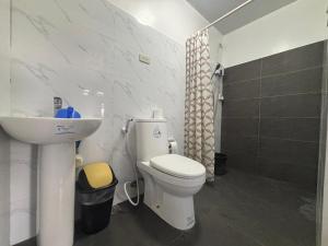 a bathroom with a white toilet and a sink at Stay at Diez in Calamba +41 photos
