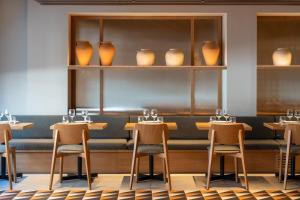 a restaurant with chairs and vases on shelves at Helios Mallorca Hotel & Apartments in Can Pastilla