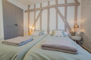 a bedroom with two beds with towels on them at La louvière in Jeugny