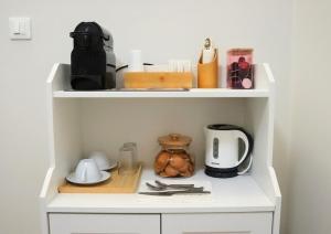 a white shelf with a coffee maker and utensils at Orto dei Frati in Sortino