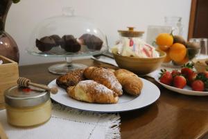 a table topped with plates of pastries and fruit at Orto dei Frati in Sortino