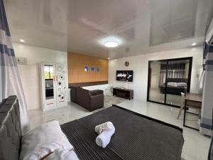 a bedroom with a bed and a desk and a mirror at Stay at Diez in Calamba