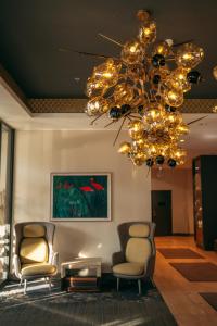 a living room with two chairs and a chandelier at V Spa & Conference Hotel in Tartu