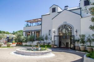 a church with a fountain in front of a building at The Weinberg Windhoek in Windhoek