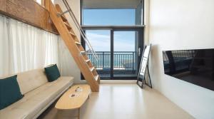 a living room with a couch and a ladder at Capella Oceanview Spa Resort – Goseong in Goseong +5 photos