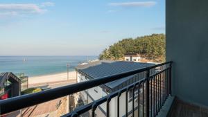 a balcony with a view of the beach at Capella Oceanview Spa Resort – Goseong in Goseong