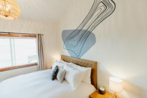 a bedroom with a bed and a painting on the wall at Mt Stimson Suite Work-From-Anywhere-Ready in Kalispell