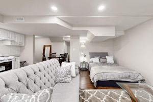 a living room with a bed and a couch at The Boxwood Executive Suite in Markham