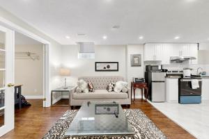 a living room with a couch and a kitchen at The Boxwood Executive Suite in Markham