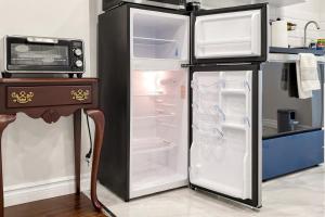 a refrigerator with its door open in a kitchen at The Boxwood Executive Suite in Markham