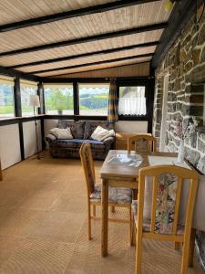 a living room with a table and chairs and a couch at Haus Hubertus in Willingen