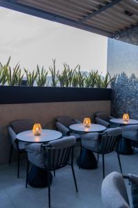 a row of tables in a restaurant with lights on them at Punto Suites Periférico Sur in Mexico City
