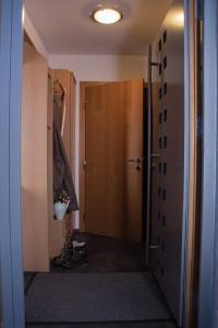 a hallway with a door leading into a room at Ferienwohnung Götzis in Götzis +1 photo