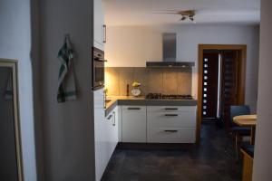 a kitchen with white cabinets and a stove top oven at Ferienwohnung Götzis in Götzis