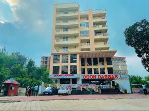 a building with cars parked in front of it at The Sandstone Studio in Dehradun