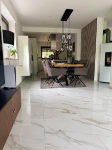a living room with a table and a dining room at A nice cozy romantic home in Bielefeld