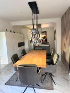 a dining room with a wooden table and chairs at A nice cozy romantic home in Bielefeld