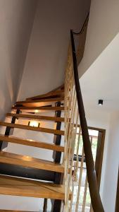 a wooden staircase in a house with a window at A nice cozy romantic home in Bielefeld