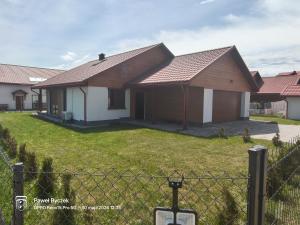 a house with a fence in front of it at Willa Kwiat Jabłoni in Mikołajki