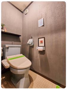 a bathroom with a white toilet in a room at NEXTRAVELER iNN in Osaka +66 photos