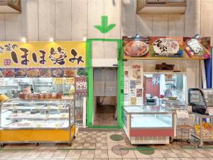a store with a bakery with food on display at NEXTRAVELER iNN in Osaka