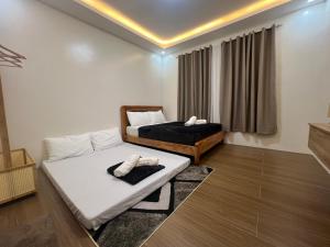 a living room with two beds and a window at Casa De Una Tagaytay in Galicias