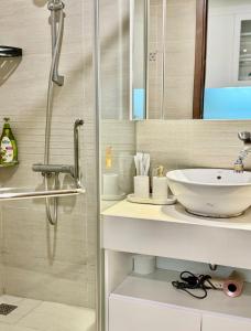 a bathroom with a sink and a shower at QM House 08 in Hanoi +2 photos
