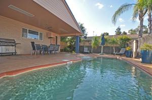 a swimming pool in the backyard of a house at Edward Parry Motel and Apartments in Tamworth