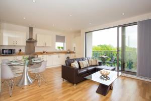 a living room with a couch and a table at Western Gate, Executive Central Apartments in Basingstoke