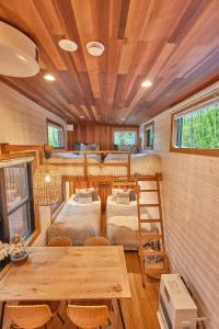 a room with two bunk beds and a table at TinyCabinTATEGU#01 - Vacation STAY 04108v in Miyota
