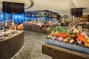 a buffet line in a hotel with lots of food at Hilton Zhuzhou in Zhuzhou