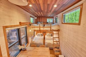 a tiny house with two bunk beds and a table at TinyCabinTATEGU#01 - Vacation STAY 04108v in Miyota
