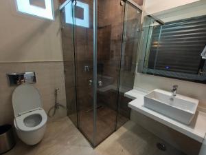 a bathroom with a shower and a toilet and a sink at Hotel Galaxy international Delhi igi Airport Free pickup in Ghaziabad