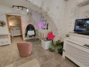 a living room with a tv on a wall at La Bombonière & Spa in Roquebrune-Cap-Martin