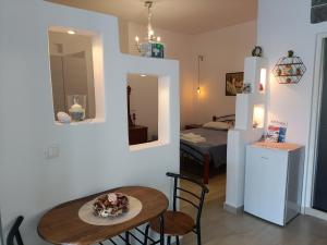 a room with a table and a room with a bed at Gorgona in Loutra +11 photos