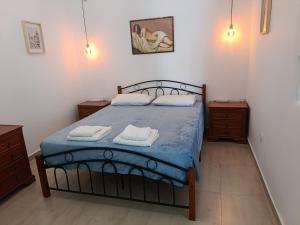 a bedroom with a bed with two towels on it at Gorgona in Loutra