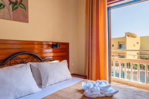 a bedroom with a bed and a balcony with a view at Kato Stalos Mare in Stalos +71 photos