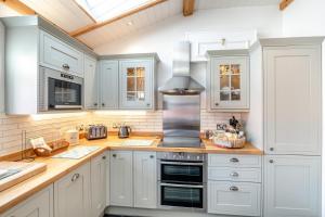 a kitchen with white cabinets and a stove top oven at 2 Bed in Scarborough oc-sa003 in Ravenscar