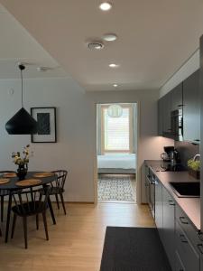 a kitchen with a table and a dining room at Tikka Apartments in Jyväskylä +7 photos