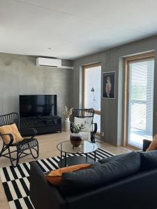 a living room with a couch and a table at Tikka Apartments in Jyväskylä