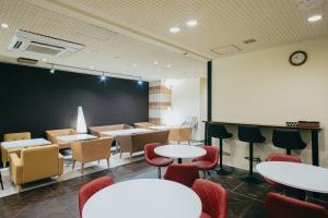 a waiting room with tables and chairs and a chalkboard at Hamamatsu Station Hotel in Hamamatsu