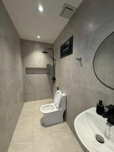 a bathroom with a toilet and a sink at Etlaala Chalet in Ibri +9 photos