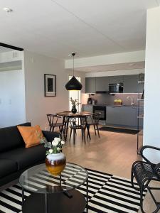 a living room with a couch and a table at Tikka Apartments in Jyväskylä