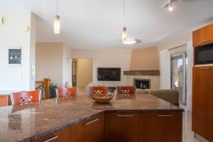 a kitchen with a center island with a bowl on it at Elysian View Estate in Faliraki
