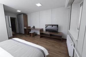 a bedroom with a bed and a television in it at mh town in Ulaanbaatar