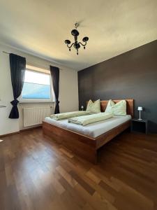 a bedroom with a large bed and a window at chapter-one in Innsbruck +16 photos