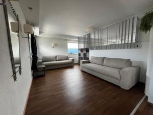 a living room with two couches and a staircase at chapter-one in Innsbruck
