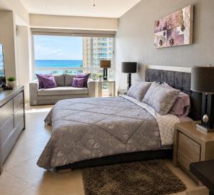 a bedroom with a bed and a view of the ocean at Luxury Beachfront Condo at Del Canto Residences - Amazing Views! in Nuevo Vallarta +22 photos